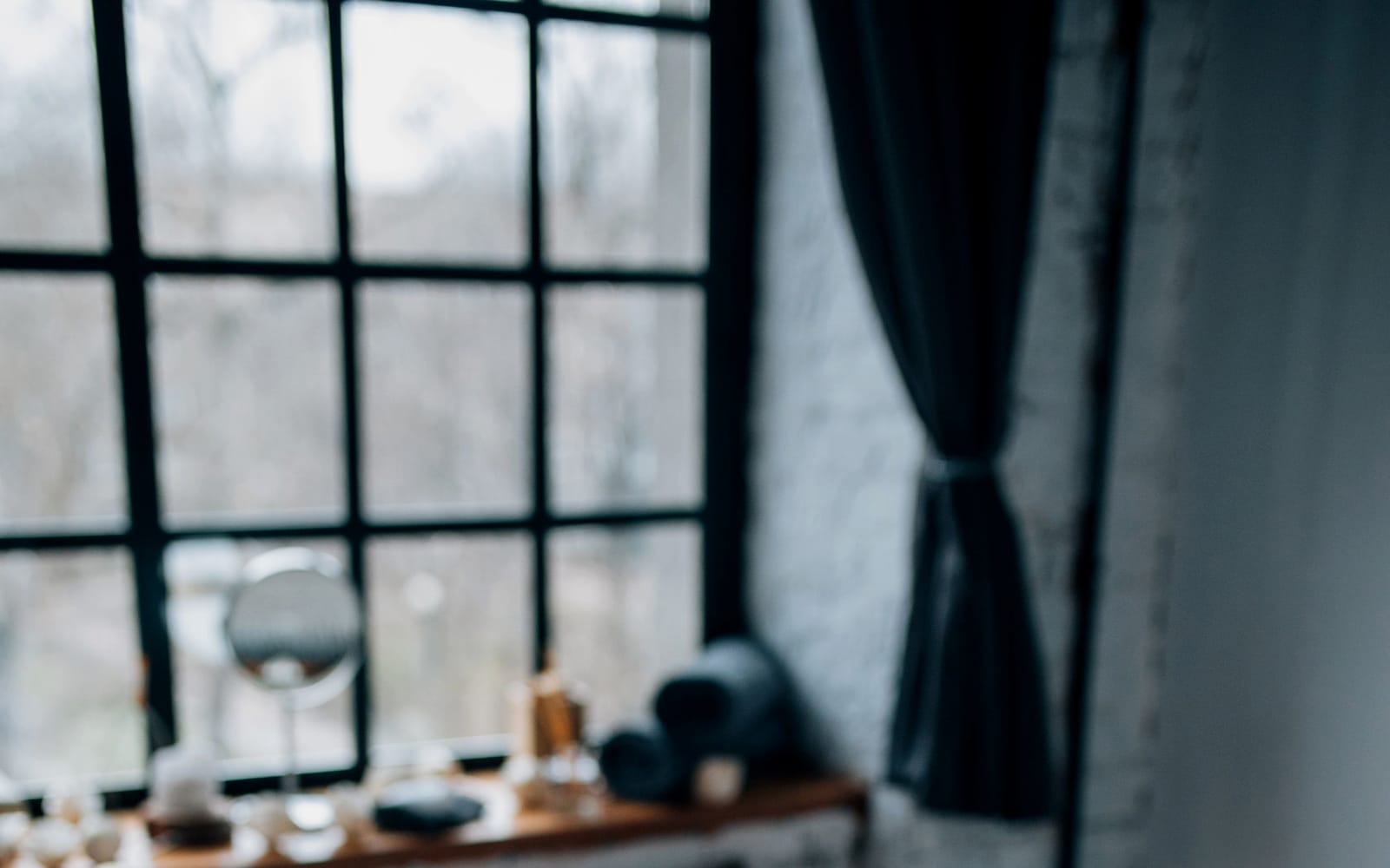 A calm room lit by a single warm lamp with a folded blanket on the table